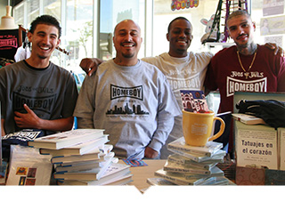 Four Homeboy Industry employees in Los Angeles pose with merchandise